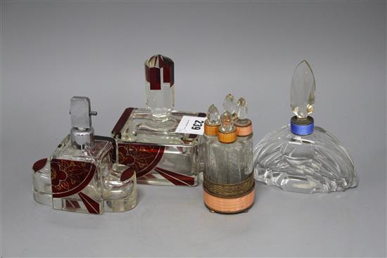 An Eastern European ruby overlaid glass scent flask and matching casket, a cut glass scent bottle with blue enamelled collar and